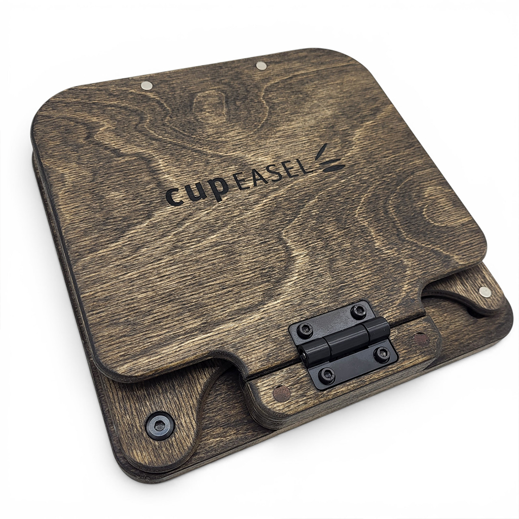 Lite Easel Oil Kit by Cup Easels Inc. includes various art supplies for oil painting, displayed on a sturdy tabletop easel.